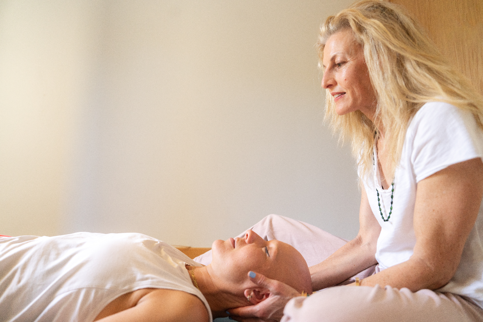 Naomi cradling a client’s head during a gentle Feldenkrais session